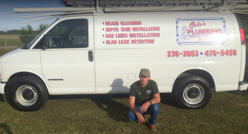 image of the owen in front of his plumbing vehicle